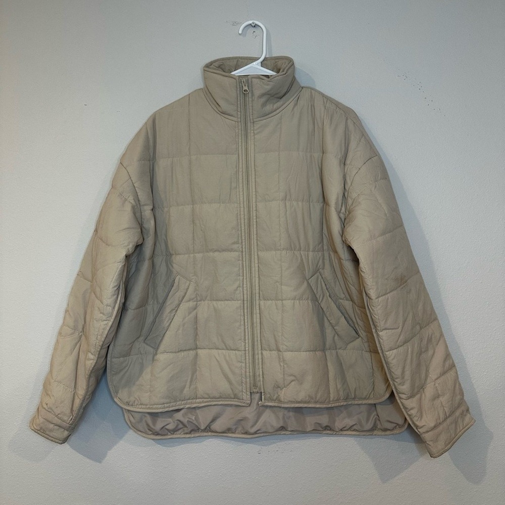 Beige puffer coat in a women's size‎ large.